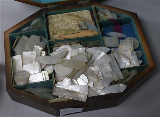 A Regency elongated octagonal games box, parquetry veneered, containing approximately 360 etched mother
